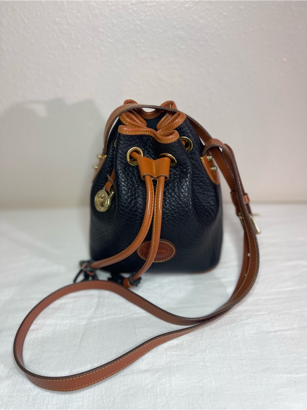 Dooney & Bourke Navy Blue Pebbled Leather Drawstring Crossbody with Brown Trim